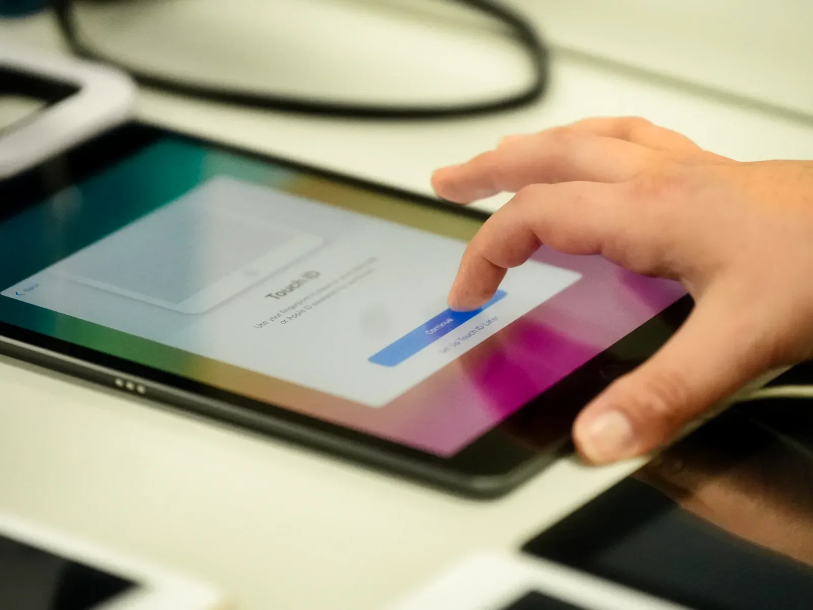 Technician taps through the setup screen on a freshly wiped iPad after NIST 800-88 data sanitization