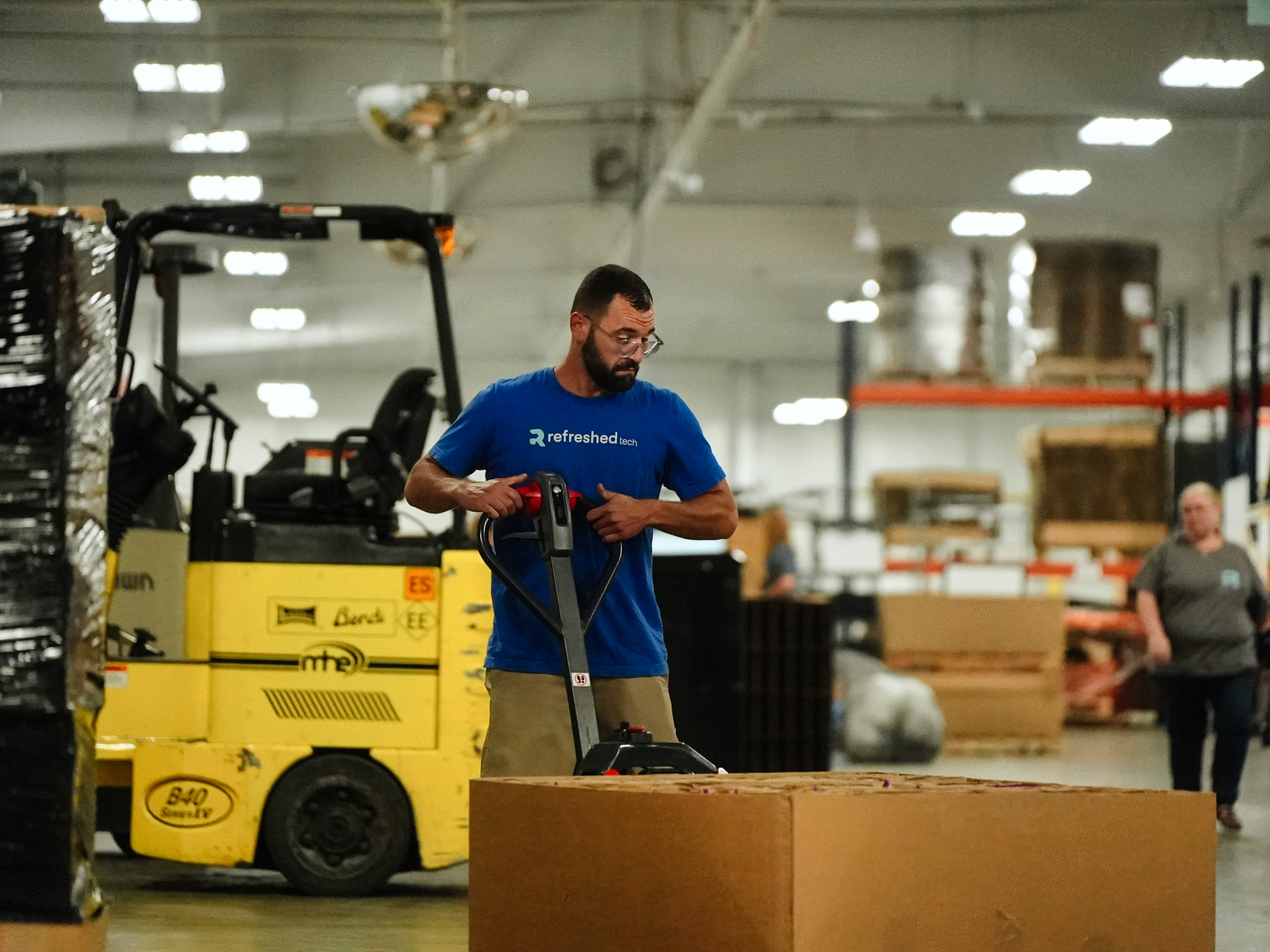 A Refreshed Tech team member moving pallets in the Ashley, Indiana facility
