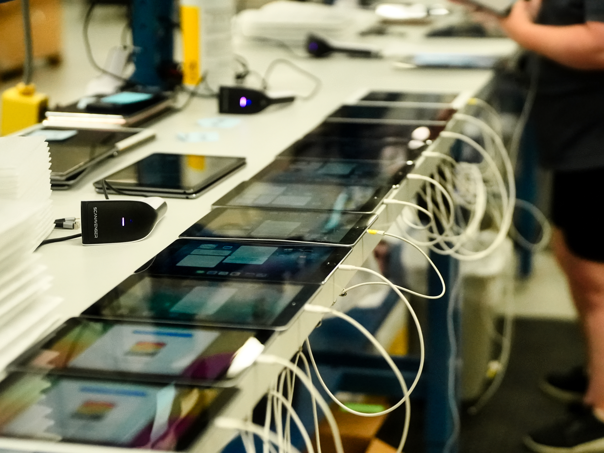 Rows of tablets on the intake and grading bench at Refreshed Tech